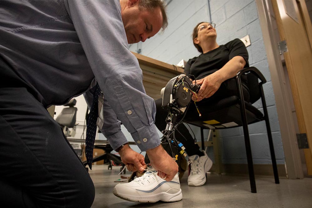Man tying an athletic shoe on a prosthetic foot